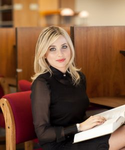 A female student holding a book